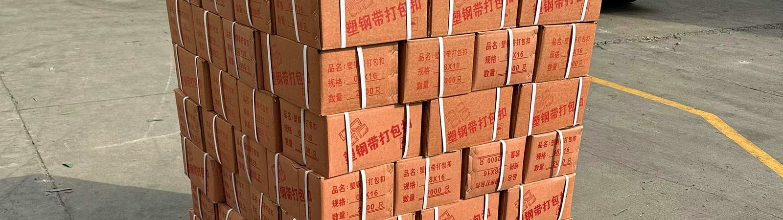 Construction building material pallets secured with PET strapping