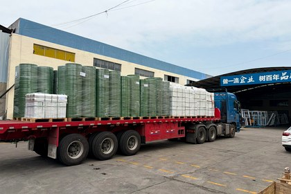Long construction bundles staged for PET strap route review